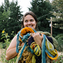 Katy Anastasi holds a tangle of colorful yarn and smiles at the camera